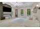 Modern living room with fireplace, TV, hardwood floors, and plenty of natural light at 10125 Bethel Church Rd, Midland, NC 28107