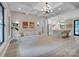 Bright, open living room with modern chandelier, connecting to a spacious kitchen with marble countertops at 10125 Bethel Church Rd, Midland, NC 28107