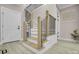 Elegant staircase featuring wooden accents, black metal railings, and light wood floors at 10125 Bethel Church Rd, Midland, NC 28107