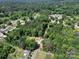 An aerial view of a road intersection surrounded by verdant forests and interspersed buildings at 1029 Sullivan St, Wadesboro, NC 28170