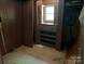 Image of a small bedroom with damaged walls, small closet with drawers, and old flooring at 1029 Sullivan St, Wadesboro, NC 28170