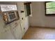 This distressed room features a window AC unit, damaged walls, and outdated flooring that needs repairs at 1029 Sullivan St, Wadesboro, NC 28170