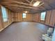 Unfinished basement space, ready for customization, with natural light and wood-paneled walls at 106 Greentree Dr, Mount Holly, NC 28120