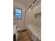 Bright bathroom featuring a bathtub with tiled walls and a modern storage niche at 106 Greentree Dr, Mount Holly, NC 28120