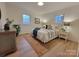 Bedroom with neutral walls, natural light, wood floors, and comfortable furniture at 106 Greentree Dr, Mount Holly, NC 28120