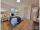 Cozy bedroom with light wood floors, neutral walls and a large window for natural light at 106 Greentree Dr, Mount Holly, NC 28120
