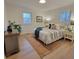 Well-lit bedroom featuring natural light, wood floors, neutral colors and comfortable furnishings at 106 Greentree Dr, Mount Holly, NC 28120