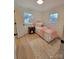 Charming bedroom with a plush bed, a wooden bedside table, and inviting natural light at 106 Greentree Dr, Mount Holly, NC 28120