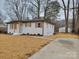 Charming one-story home with white brick, wood accents, and a well-manicured lawn at 106 Greentree Dr, Mount Holly, NC 28120