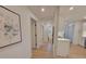 Hallway leading to kitchen with white walls, light flooring, and modern decor at 106 Greentree Dr, Mount Holly, NC 28120