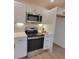Close up of modern kitchen with stainless steel oven, microwave, custom backsplash and white cabinets at 106 Greentree Dr, Mount Holly, NC 28120