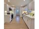 Modern kitchen featuring white cabinets, stainless steel appliances, and tile backsplash at 106 Greentree Dr, Mount Holly, NC 28120