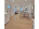 Open concept living and dining area with light wood floors, white walls and modern finishes at 106 Greentree Dr, Mount Holly, NC 28120
