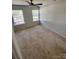 This well-lit bedroom features neutral carpet, a ceiling fan, and two bright windows at 10649 Trolley Run Dr, Cornelius, NC 28031