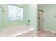 Bright bathroom featuring a tub and separate shower with a decorative window at 1071 Bassett Way, Fort Mill, SC 29707