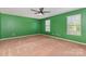 Spacious bedroom featuring neutral carpet, green walls, and multiple windows at 1071 Bassett Way, Fort Mill, SC 29707