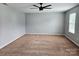 Spacious bedroom features neutral walls, carpet flooring and ceiling fan with light fixture at 1071 Bassett Way, Fort Mill, SC 29707