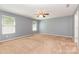 Spacious bedroom with neutral gray walls, carpet, ceiling fan and natural light at 1071 Bassett Way, Fort Mill, SC 29707