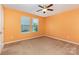 Bedroom showcasing neutral carpet, orange walls, a ceiling fan, and a window at 1071 Bassett Way, Fort Mill, SC 29707