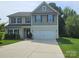 Charming two-story home with a well-manicured lawn, a two-car garage, and a welcoming front entrance at 1071 Bassett Way, Fort Mill, SC 29707