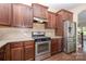 Kitchen featuring stainless steel appliances and granite countertops with wooden cabinets at 1071 Bassett Way, Fort Mill, SC 29707