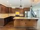 Well-equipped kitchen with stainless steel appliances, granite countertops, and dark wood cabinets at 1071 Bassett Way, Fort Mill, SC 29707