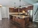 Well-equipped kitchen with stainless steel appliances, granite countertops, and dark wood cabinets at 1071 Bassett Way, Fort Mill, SC 29707