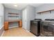 Laundry area with washer, dryer, shelving, countertop, and tiled floors at 1071 Bassett Way, Fort Mill, SC 29707