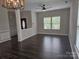 Bright living room with hardwood floors, ceiling fan, and large windows providing plenty of natural light at 1071 Bassett Way, Fort Mill, SC 29707