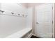 Mud room featuring white wainscotting, bench, storage, and coat hooks at 1071 Bassett Way, Fort Mill, SC 29707
