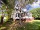 The backyard showcases the home's exterior, a fenced yard, and lush green space at 10804 Back Ridge Rd, Charlotte, NC 28277