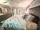 Bedroom with a large bed, gray walls, ceiling fan, dresser, and decorative butterfly wall hangings at 10804 Back Ridge Rd, Charlotte, NC 28277