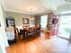 The dining room features hardwood floors, decorative molding, and a table for six underneath a modern chandelier at 10804 Back Ridge Rd, Charlotte, NC 28277