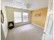 Bright empty room featuring white carpet, yellow accent wall, and a ceiling fan at 10804 Back Ridge Rd, Charlotte, NC 28277