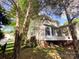 Exterior view of home featuring a fenced yard, mature trees, and a covered patio at 10804 Back Ridge Rd, Charlotte, NC 28277