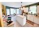 Open-concept kitchen with an island, white cabinets, stainless steel appliances, and an adjacent breakfast nook at 10804 Back Ridge Rd, Charlotte, NC 28277