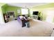 Spacious living room with bright green walls, ceiling fan, and a comfortable sofa at 10804 Back Ridge Rd, Charlotte, NC 28277