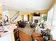This bright living room shows hardwood floors, a fireplace, a ceiling fan, a sectional sofa, and large windows at 10804 Back Ridge Rd, Charlotte, NC 28277