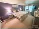 Spacious bedroom with a large bed, ceiling fan, and a dedicated desk area near a bright window at 10804 Back Ridge Rd, Charlotte, NC 28277