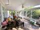 Bright and airy sunroom with wood floors and screened windows, perfect for relaxing and enjoying the outdoors at 10804 Back Ridge Rd, Charlotte, NC 28277