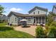Beautiful backyard with patio, dining area, and lush landscaping, ideal for outdoor entertaining at 10822 Brandie Meadow Ln, Huntersville, NC 28078