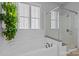 Clean bathroom showcasing a soaking tub, glass shower, and stylish fixtures at 10822 Brandie Meadow Ln, Huntersville, NC 28078