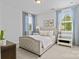 Cozy bedroom featuring a tufted headboard bed, light blue drapes and light walls at 10822 Brandie Meadow Ln, Huntersville, NC 28078