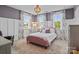 Bedroom with a pink bed frame, patterned curtains, and a chandelier for a bright space at 10822 Brandie Meadow Ln, Huntersville, NC 28078