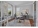 Cozy dining area featuring hardwood floors, a round table with chairs, and natural light from a window at 10822 Brandie Meadow Ln, Huntersville, NC 28078