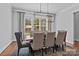 Elegant dining room with seating for six and a modern chandelier at 10822 Brandie Meadow Ln, Huntersville, NC 28078