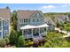 Two-story home with a charming porch, white railings, and beautiful landscaping at 10822 Brandie Meadow Ln, Huntersville, NC 28078