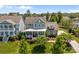 Inviting two-story home with a charming porch, white railings, and beautiful landscaping at 10822 Brandie Meadow Ln, Huntersville, NC 28078