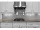 Modern kitchen featuring stainless steel appliances, granite countertops, stylish backsplash, and ample cabinet space at 10822 Brandie Meadow Ln, Huntersville, NC 28078