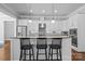 Stylish kitchen with white cabinets, granite countertops, and seating at the breakfast bar at 10822 Brandie Meadow Ln, Huntersville, NC 28078